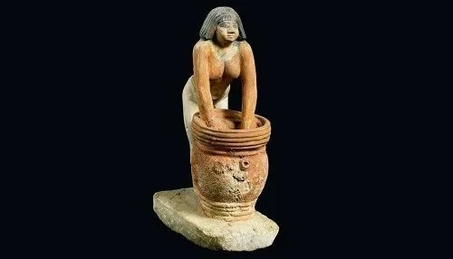 Egyptian woman mixing barley bread with water Egyptian woman mixing barley bread with water