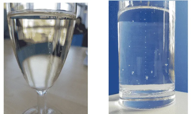 Burbujas en una copa de Prosseco y una copa de agua Burbujas en una copa de Prosseco y una copa de agua