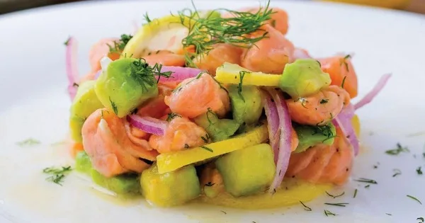 Ceviche con cerveza gose Ceviche de salmón fresco marinado con cerveza Gose, aguacate, cebolla morada y cilantro.
