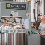Operario ajusta una unidad de captura de CO2 Earthly Labs en una cervecería